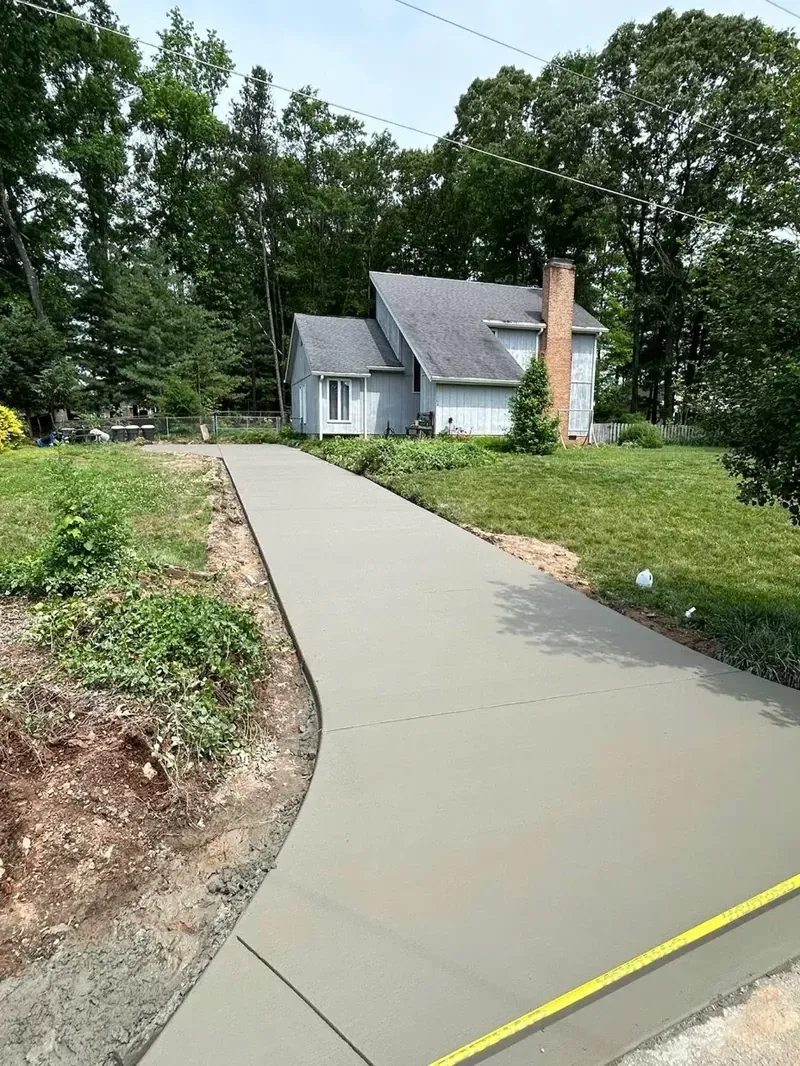 Long curved residential concrete driveway leading up to a Lake Norman lakefront home | Old North Concrete Co.