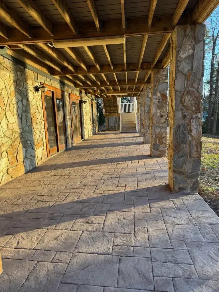 Finished stamped concrete patio in warm earth tones at a Lake Norman home | Old North Concrete Co.